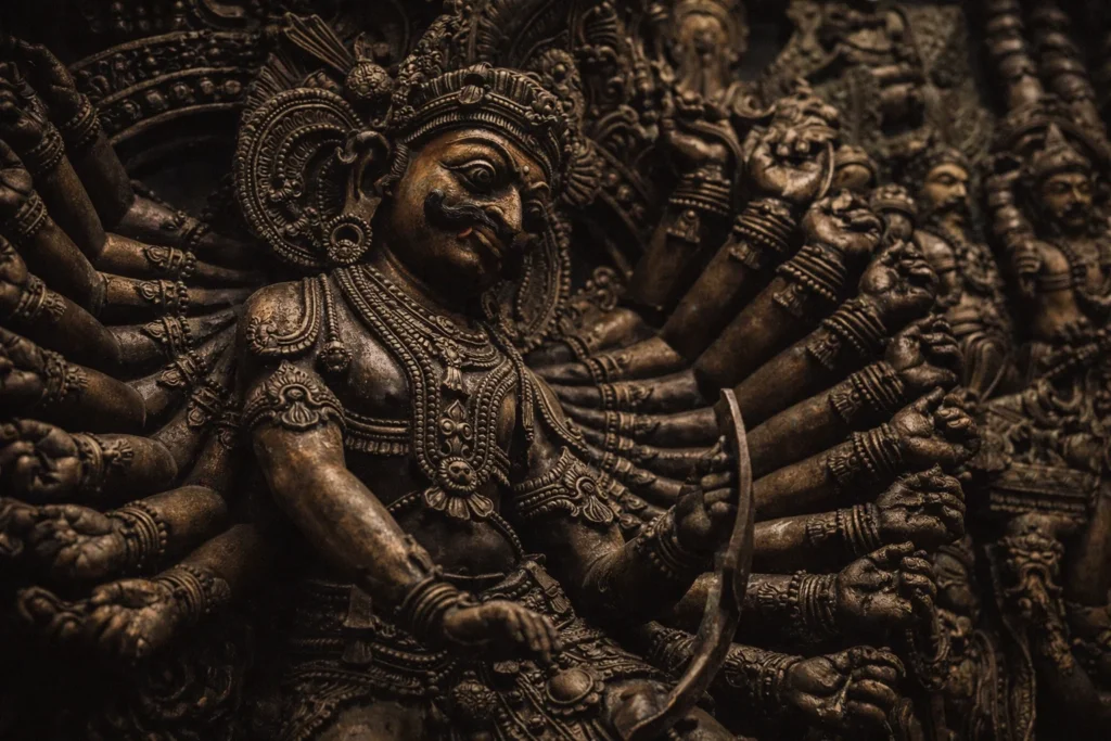 Detailed bronze-colored sculpture of Banasura with his thousand arms